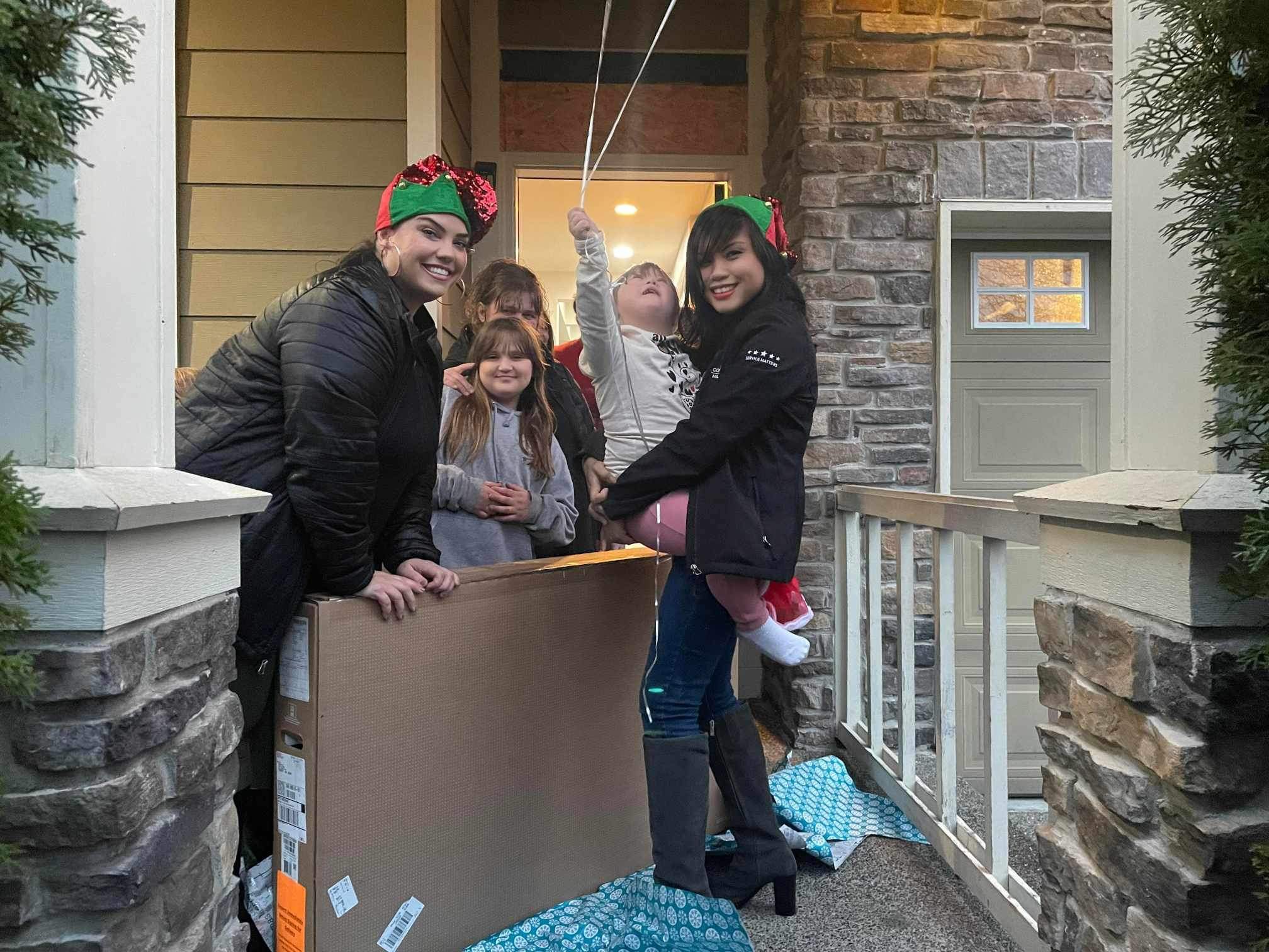 Comcast employees surprise a family at their home with a TV.